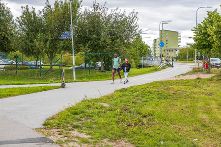 Beautiful view of young man and woman walking in city on summer day. Sweden. Uppsala. 05/09/2021.のeditorial素材