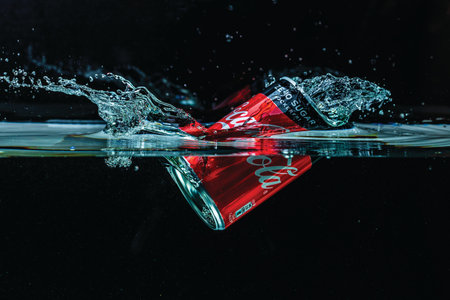Close up view of coca falling in water on black background. Gorgeous backgrounds. 09.12.2021....