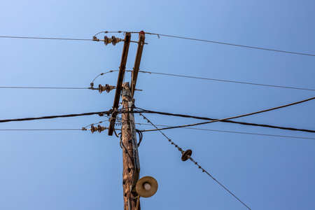 Beautiful view of old power line on blue sky background. Greece.の写真素材