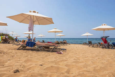 Beautiful view of tourists on sand beach on sunny summer day. Greece. Nea Potidaea. 09/03/2021.のeditorial素材