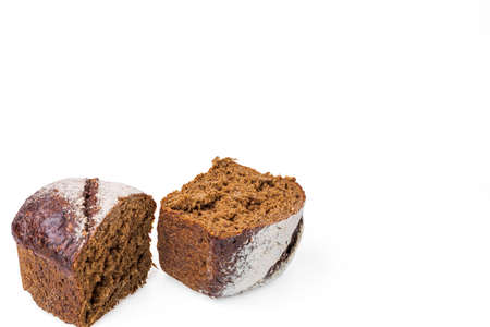 Close up view of cut dark loaf bread isolated on white background.の写真素材