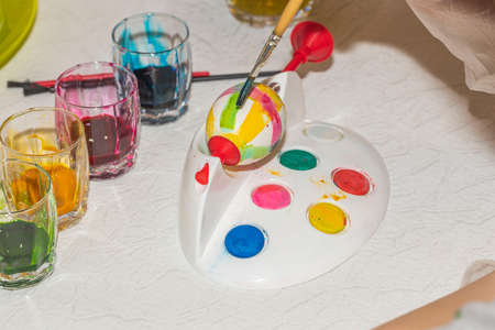 Close up view of child painting eggs for Easter. Holiday concept. Sweden.の写真素材