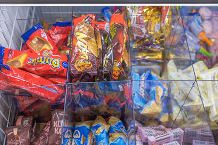 Close up view of different varieties of ice cream lying in freezer in store. Sweden. Uppsala. 11.19.2021.のeditorial素材