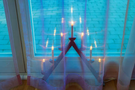 Beautiful view of the interior of a room with a traditional Christmas candlestick standing on the floor. Sweden.の写真素材