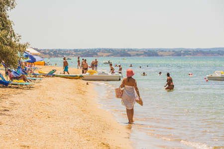 Beautiful view of tourists on sand beach on sunny summer day. Greece. Nea Potidaea. 03/09/2021.のeditorial素材