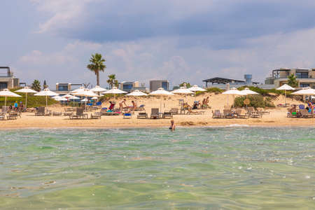 Beautiful colorful view of resort beach on blue sky with white clouds background. Greece. Nea Potidaea. 08.25.2021.のeditorial素材