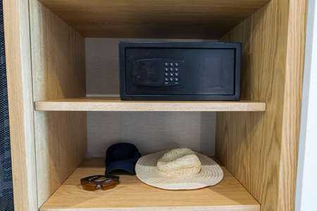 Close up interior view of belongings and safety deposit box in hotel's wardrobe. Greece.の写真素材