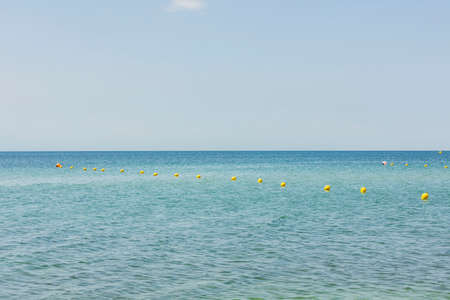 Wonderful views of turquoise waters of Mediterranean with swimming buoys. Beautiful nature background. Greece.の写真素材