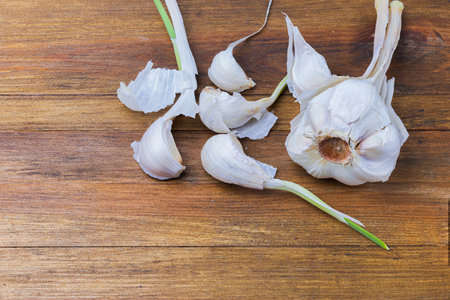 Close up view of garlic isolated on wood background. Beautiful background.