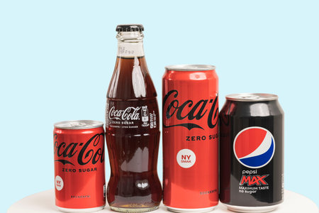 Beautiful view of different kinds of Coca-Cola and Pepsi cola sugar free isolated on blue...