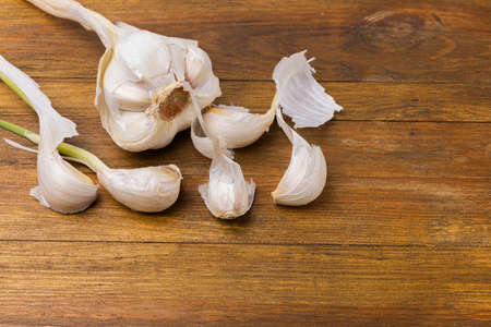 View of garlic isolated on wood background. Beautiful background.の写真素材