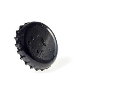 Close up view of black metal cap with drops isolated on white background.の写真素材