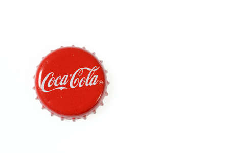 Close up view of Coca Cola metal cap isolated on white background. Sweden. Uppsala. 08/01/2022.のeditorial素材