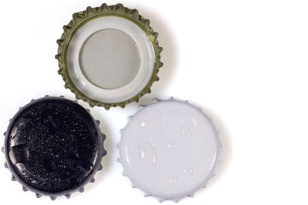 Close up view of three different black and white metal caps with drops isolated on white background.の写真素材