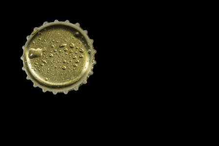 Close up view of metal cap with drops isolated on black background.の写真素材