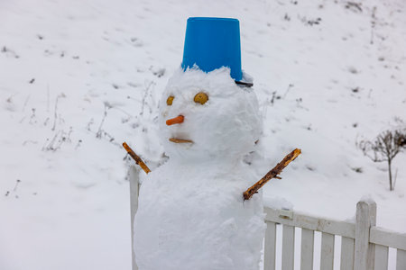 Close up view of a funny snowman made children in winter garden. Beautiful winter backgrounds. Sweden.の写真素材