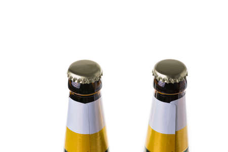 Close up view of beer bottles with metal caps isolated on white background.の写真素材