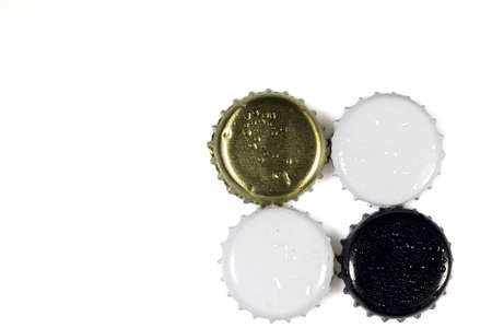 Close up view of white and black metal caps with drops isolated on white background.の写真素材
