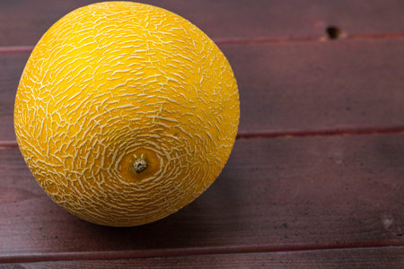 Close up view of melon isolated on wood background. Healthy food concept.