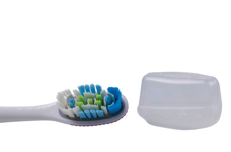 Close up view of toothbrush and protective case for travel isolated on white background.