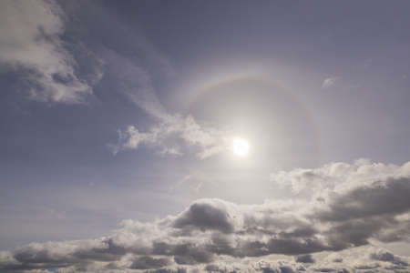 Beautiful view of sun breaking through cloudy spring sky.の写真素材