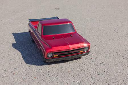 Close up front view of radio controlled vintage car model isolated on sidewalk. Sweden.