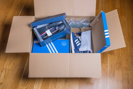 Close up view of received home delivery box with adidas and Tom Tailor shoes. Sweden. uppsala....