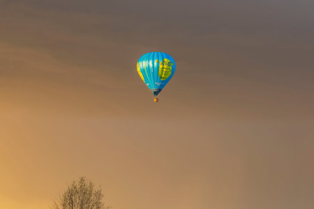 Beautiful view of Shrek hot air balloon far away in blue sky between clouds. Sweden. uppsala. 05.10.2022.のeditorial素材