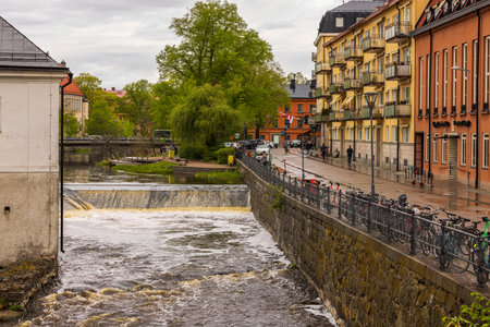 Beautiful view of historic city center with old buildings and flowing river in the center of...