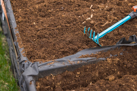 Close up view of garden rake for sowing vegetables recumbent in collar pallet. Sweden.
