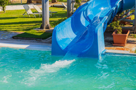 Close up view of blue waterslide at hotel outdoor pool.の写真素材