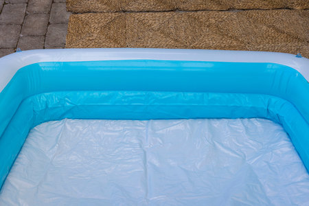 Close up view of inflatable children's pool in courtyard of house.
