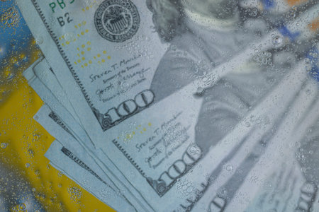 View of abstraction texture of hundred dollar bills and handcuffed underwater.