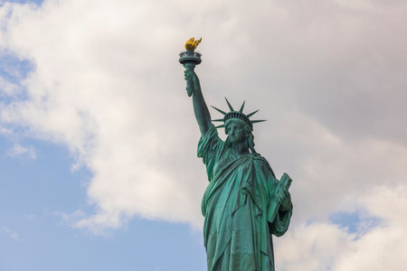 Beautiful close up view Statue of liberty on white clouds background. New York, USA.の写真素材