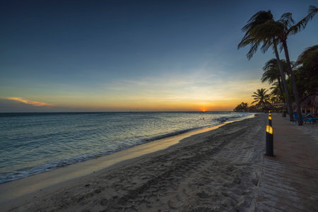 Magnificent view of sunset in Atlantic ocean from sandy beach of island of Aruba.の写真素材
