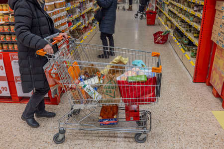 Interior view of customer with food purchases in shopping cart in ICA supermarket. Sweden. uppsala. 12.14.2022.のeditorial素材