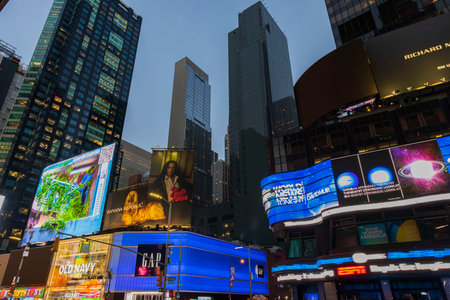 Beautiful view of night Broadway with skyscrapers in Manhattan with advertising television screens against background of night sky. new york. USA. 09.20.2022.のeditorial素材