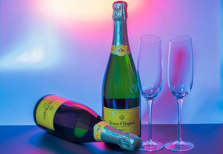 Close up view of two bottles of French brut Veuve Clicquot champagne and two thin, tall and elegant champagne glasses. uppsala. Sweden. 11/01/2023.のeditorial素材