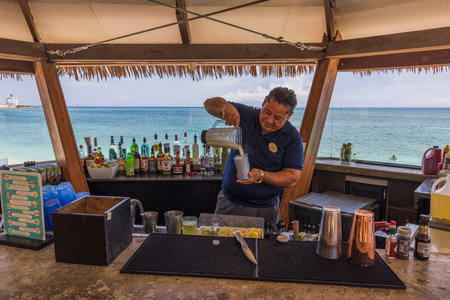 Close-up view of barman making cocktail in outdoor restaurant on coast of Atlantic Ocean. Oranjestad. Aruba. 01.30.2023.のeditorial素材