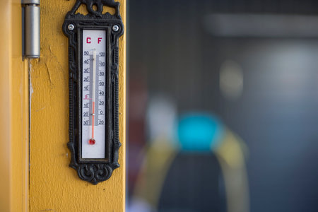 View of outdoor thermometer on yellow wooden pillar in winter day. Swedenの写真素材