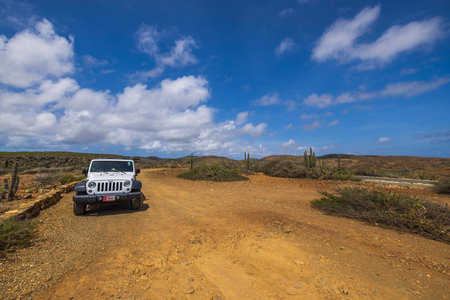 Beautiful view of white wrangler jeep in desert on national park road, Aruba. Oranjestad. 09.12.2022.のeditorial素材