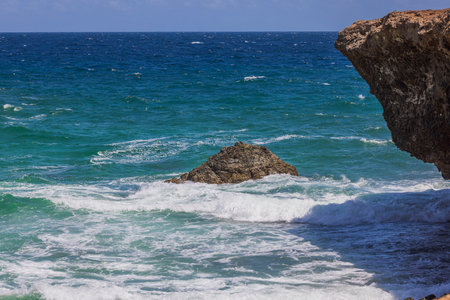 Gorgeous nature landscape view. Rocky coast washed by Caribbean sea waves. Aruba.の写真素材