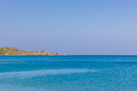 Beautiful view of blue water of Mediterranean sea against backdrop of mountains. Greece.の写真素材