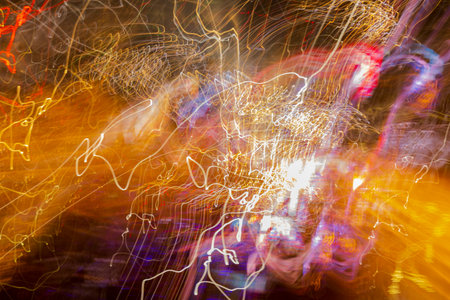 Close up out of focus view of abstract colorful with lights of passing cars.の写真素材