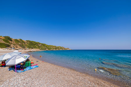 Beautiful view of family swimming and having good time on coastline wild beach. Greece. Rhodes. 08.25.2022.のeditorial素材