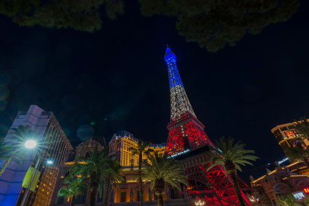 Gorgeous night view of tops of Strip's hotel buildings, with luminous blue-white-red light of Eiffel Tower. Las Vegas, Nevada, USA. 09.18.2022.のeditorial素材