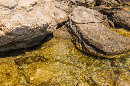 Close-up view of the rocky coastline of the Mediterranean Sea. beautiful nature backgrounds. Greece.の写真素材