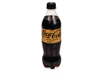 Close-up view of cold plastic sugar-free bottle with vanilla Coca Cola isolated on white background. Sweden Uppsala. 04.10.2023.のeditorial素材