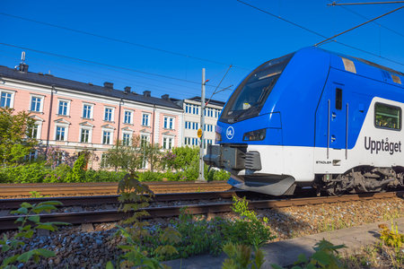 Beautiful view of city center with passing high-speed train. Sweden. uppsala. 05.23.2022.のeditorial素材