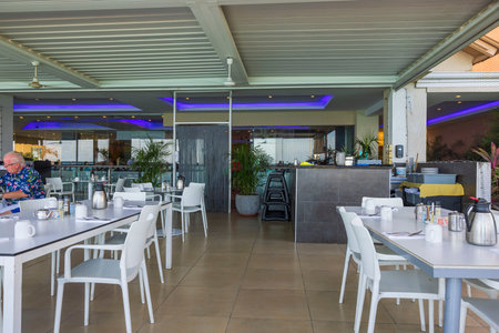 Close up view of interior view of outdoor hotel restaurant and people. Aruba. Caribbean Islands. 04.15.2023.のeditorial素材